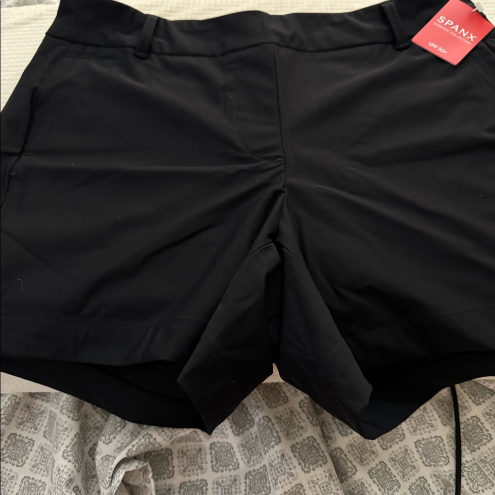 Brand new pair of Spanx shorts that are black with pockets.